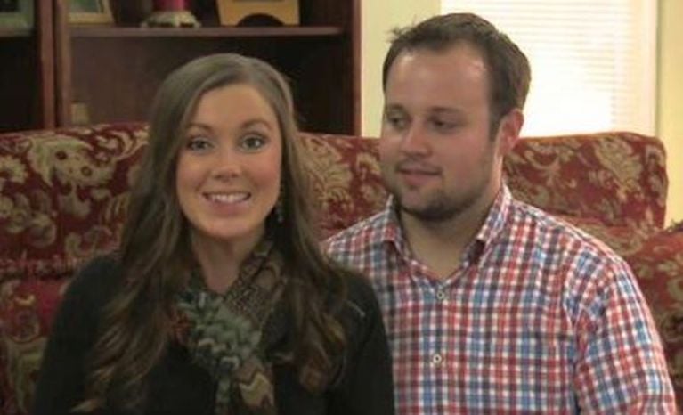 Now-disgraced criminal Josh Duggar sits beside wife Anna Duggar on 19 Kids and Counting.