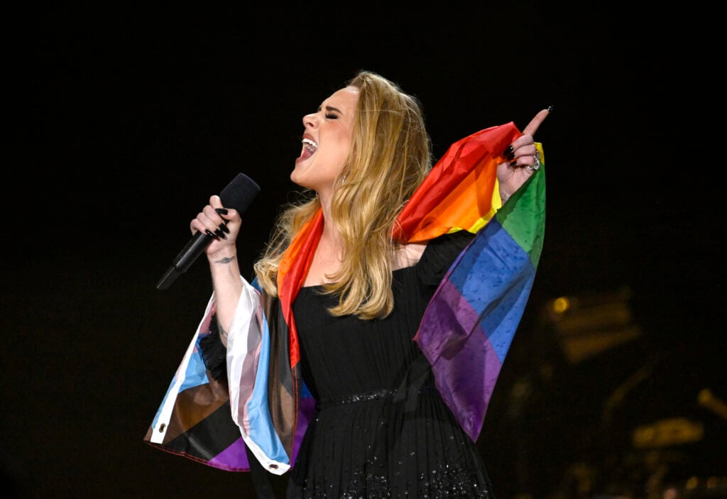 Adele adorned by two pride flags in July of 2022.