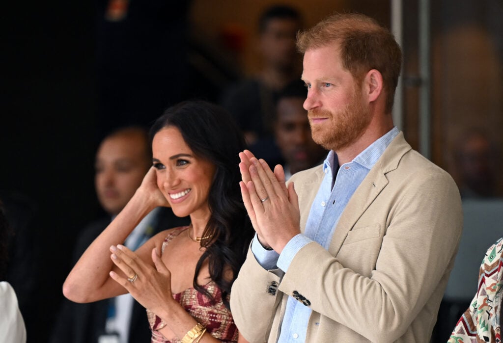 Britain's Prince Harry, Duke of Sussex, and his wife Meghan Markle react while attending a show during a visit to the National Centre for the Arts in Bogota on August 15, 2024. 