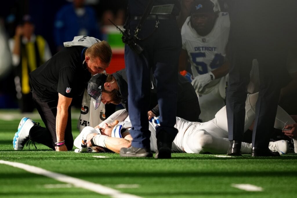 Aidan Hutchinson's injury captured as he struggles in pain on the field. 